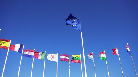 Flags of European countries against the blue sky. Smooth slowmotion from a 120 fps original shoot