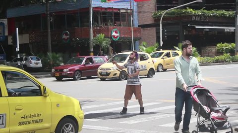 Medellin, Colombia - July 2, 2018: A young Venezuelan immigrant makes a street performance in Colombia