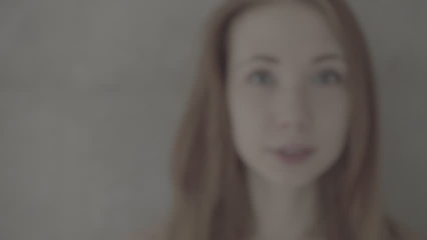Close up beauty portrait of face of a lovely young woman with looking directly at the camera