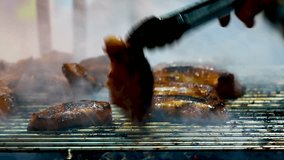 Daily life Video The chef's hand is grill the barbecue thai style with charcoal and smoke at Street food or night market in thailand,Food and Travel concept