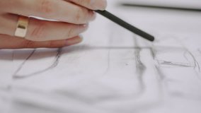 Woman-architect draws a sketch of the future house - Powered by Shutterstock - Get 15% off with code: PIKWIZARD15