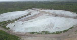 4K aerial cloudy day high quality video of rubbish refuse site with birds flying and feeding near town Vyborg in Saint Petersburg area in northern-western Russia near border with Finland