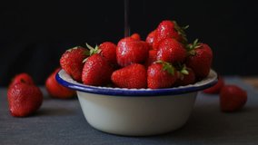 Fresh strawberries. Strawberry on dark background. Seamless cinemagraph video