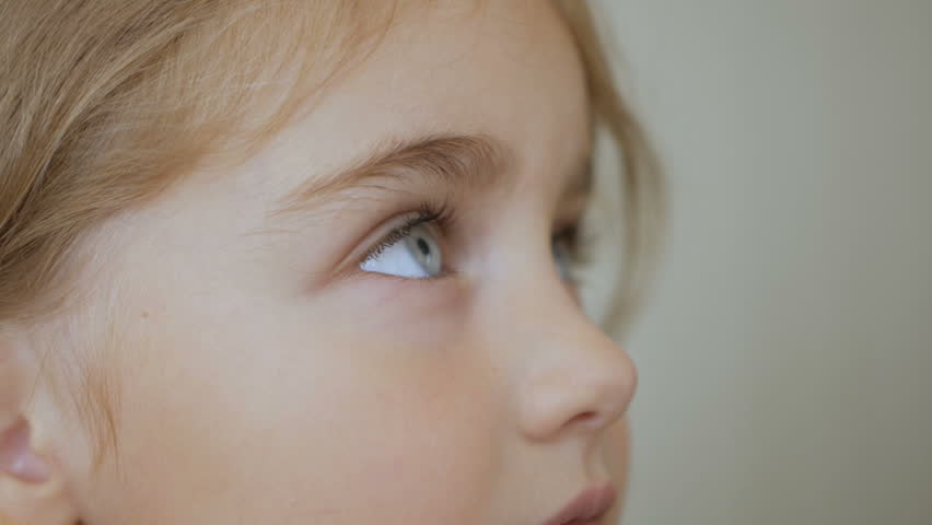 Portrait little young girl with blue eyes looking up. Closeup | Shutterstock HD Video #1013151461