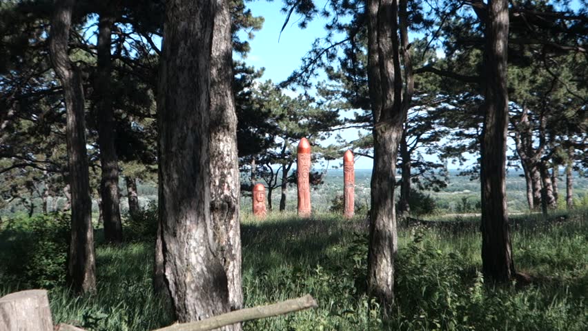 Real pagan altar in the forest with idols in summer light