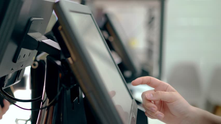 Cashiers are working, touching the touch screen, choosing the right products.  Royalty-Free Stock Footage #1013152016