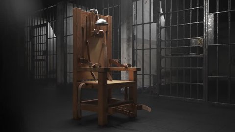 03495 Electric chair in the prison block. Camera pans around it.