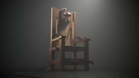03496 Electric chair in the spotlight. Camera pan.