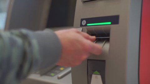 Credit card entry to ATM hand uses bank card. Getting cash in a safe way. Financial security and banking system concept. Operation with electronic money.
