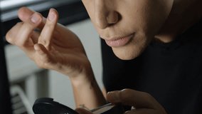 Close-up of a transgender woman putting eye shadow on with her finger