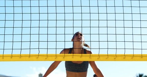 Female volleyball player playing volleyball in the beach 4k