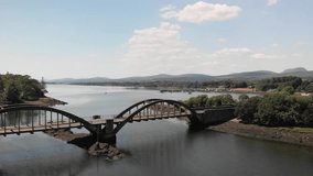 Aerial video passing over the arched bridge located on the Kenmare Estuary, leading out passed the pier towards the Atlantic Ocean.