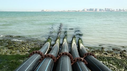 Pipes for intake of sea water and desalination in Doha, Qatar. Desalinization of sea water for city needs, water intake from Persian Gulf, Arabian Peninsula