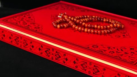 rosary and Holy Quran book,