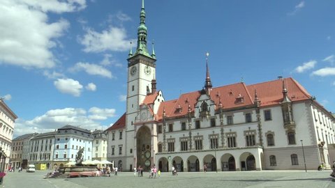 OLOMOUC, CZECH REPUBLIC, JULY 5, 2018: City Hall tower and historic buildings in Olomouc and astronomical clock, Horni namesti square, people go and drive car