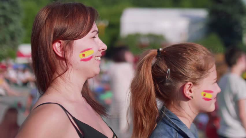 Side view of girls supporting Spanish team 