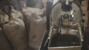 Man checking coffee beans in roasting machine