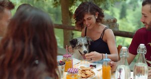 group of friends doing breakfast outdoors in a traditional countryside. shot in slow motion