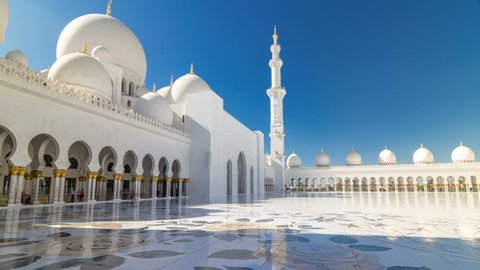 Sheikh Zayed Grand Mosque timelapse hyperlapse in Abu Dhabi, the capital city of United Arab Emirates. Inner court yard. Blue sky at sunny day