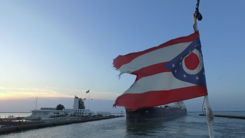 The Ohio Flag blowing in the wind at the front of the Nautica Queen in Cleveland, Ohio. Right on the mouth of the Cuyahoga River flowing into Lake Erie.