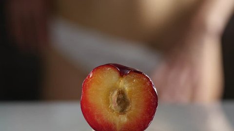 close-up half peach, woman takes off and puts on her panties. imitation vagina. 4K