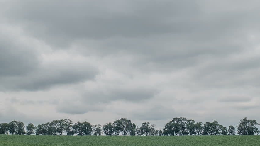 Rain clouds at green field