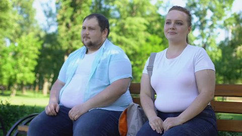 Obese couple on first date, man tenderly taking girlfriend hand, love and care