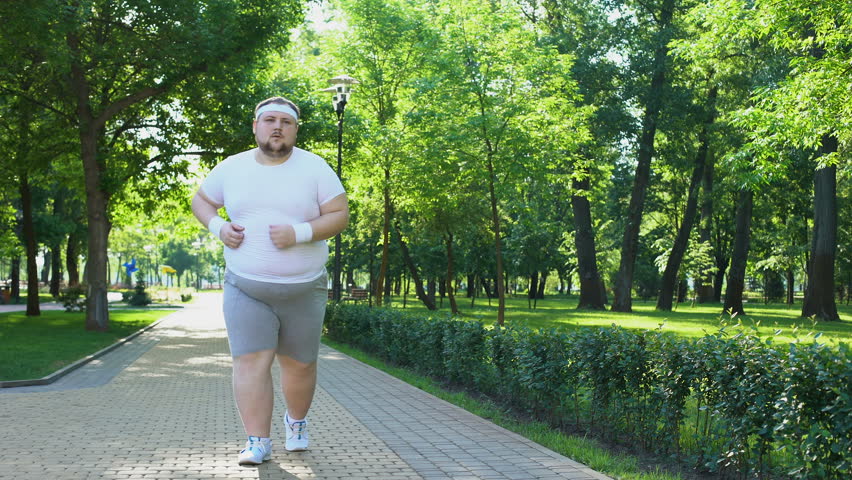 Purposeful fat man running in park, out of breath, persistent motivation | Shutterstock HD Video #1013227823