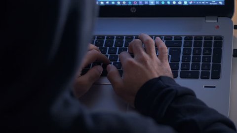 focus on hooded hacker attacking the system - Βίντεο στοκ