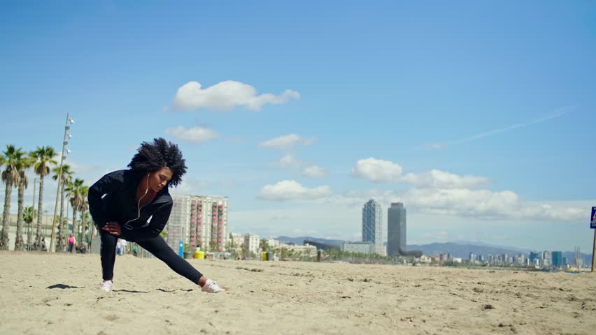 Beautiful young happy black girl excercising outdoors