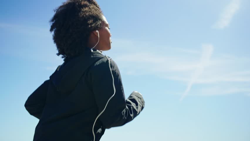 Beautiful young happy black girl excercising outdoors
