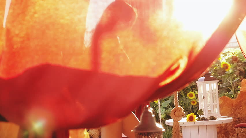 Beautiful woman entering in tub in sunflower garden at sunset slow motion