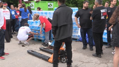 Toronto, Ontario, Canada July 2018 Toronto aid workers load plastic water bottles for the homeless during heatwave