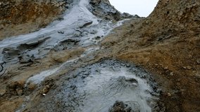 Boiling muddy bubbles in crater of mud volcano of Gobustan near Baku, Azerbaijan, v03