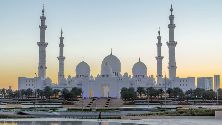 Sheikh Zayed Grand Mosque in Abu Dhabi day to night transition timelapse after sunset, UAE. Evening view from Wahat Al Karama with reflections on water | Shutterstock HD Video #1013248037