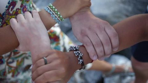 To unite different races, people with a skin of different colors are taken for each other in a crisp handshake. HD, 1920x1080, slow motion.