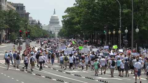 WASHINGTON, DC - JUNE 30, 2018: Protesting Trump's zero tolerance immigration policy & family detention and separation, thousands march from rally to Justice Dept during Families Belong Together march