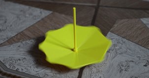 yellow small and plastic umbrella spin around its axis