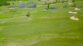 Raw drone video of a lawnmower on a golf course