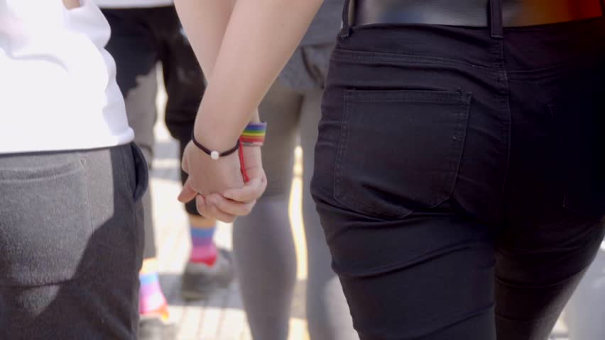 Lesbian Couple Walking Hand To Hand In Pride Day  Royalty-Free Stock Footage #1013255102