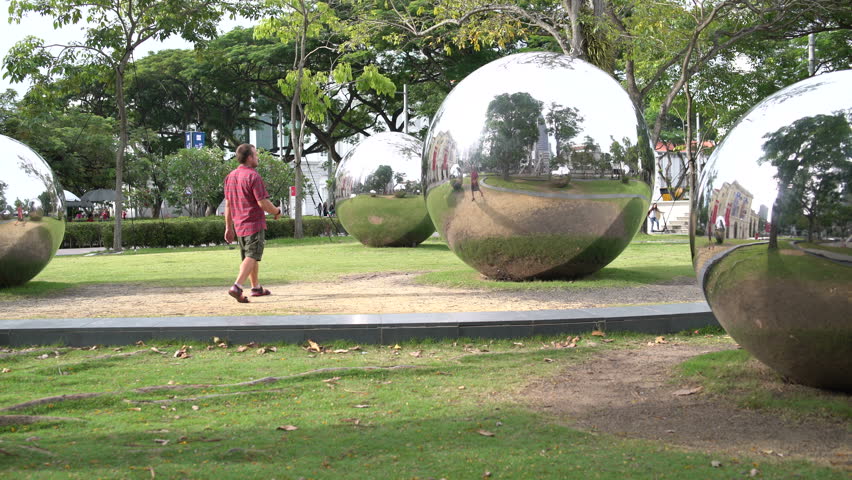 A man makes a serf ryados with large mirror balls