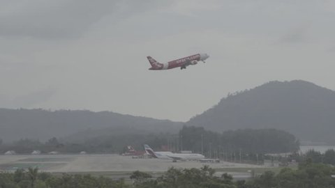 PHUKET, THAILAND - NOVEMBER 27, 2016: Airbus A320 of AirAsia takes off at the airport of Phuket International. S-log, ungraded