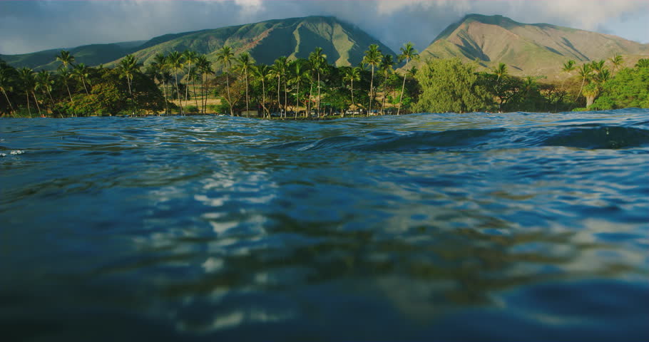 Beautiful view of West Maui Mountains at sunset from in the ocean