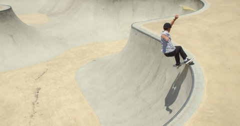 High angle of man skateboarding grinding pool coping