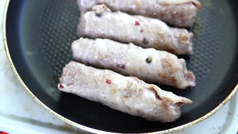 Preparation of meat dish from minced meat wrapped in bacon with white veins. 