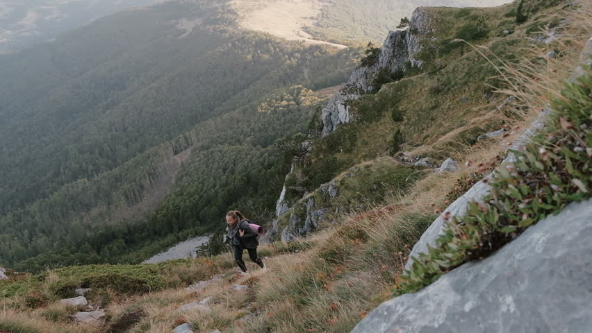 Woman  hiker  traveling in the mountains Komovi in Montenegro and enjoying vacation holiday travel adventure. Slow motion