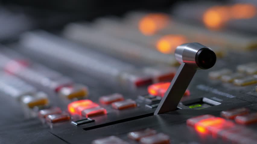 television director is moving handle on a control panel during tv filming in studio Royalty-Free Stock Footage #1013312621