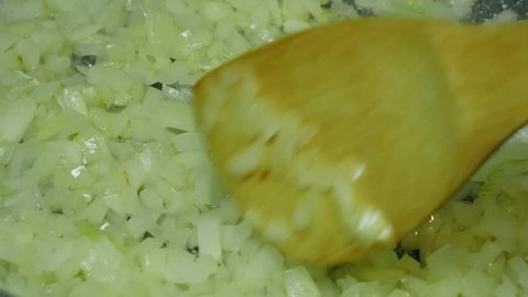 Fry onion in a frying pan close up