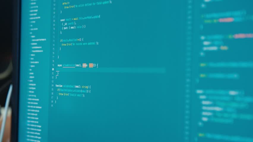 computer programmer sitting in front of a screen coding software