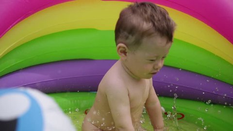 child mestizos in the children's pool.one-year-old child, Asian appearance.